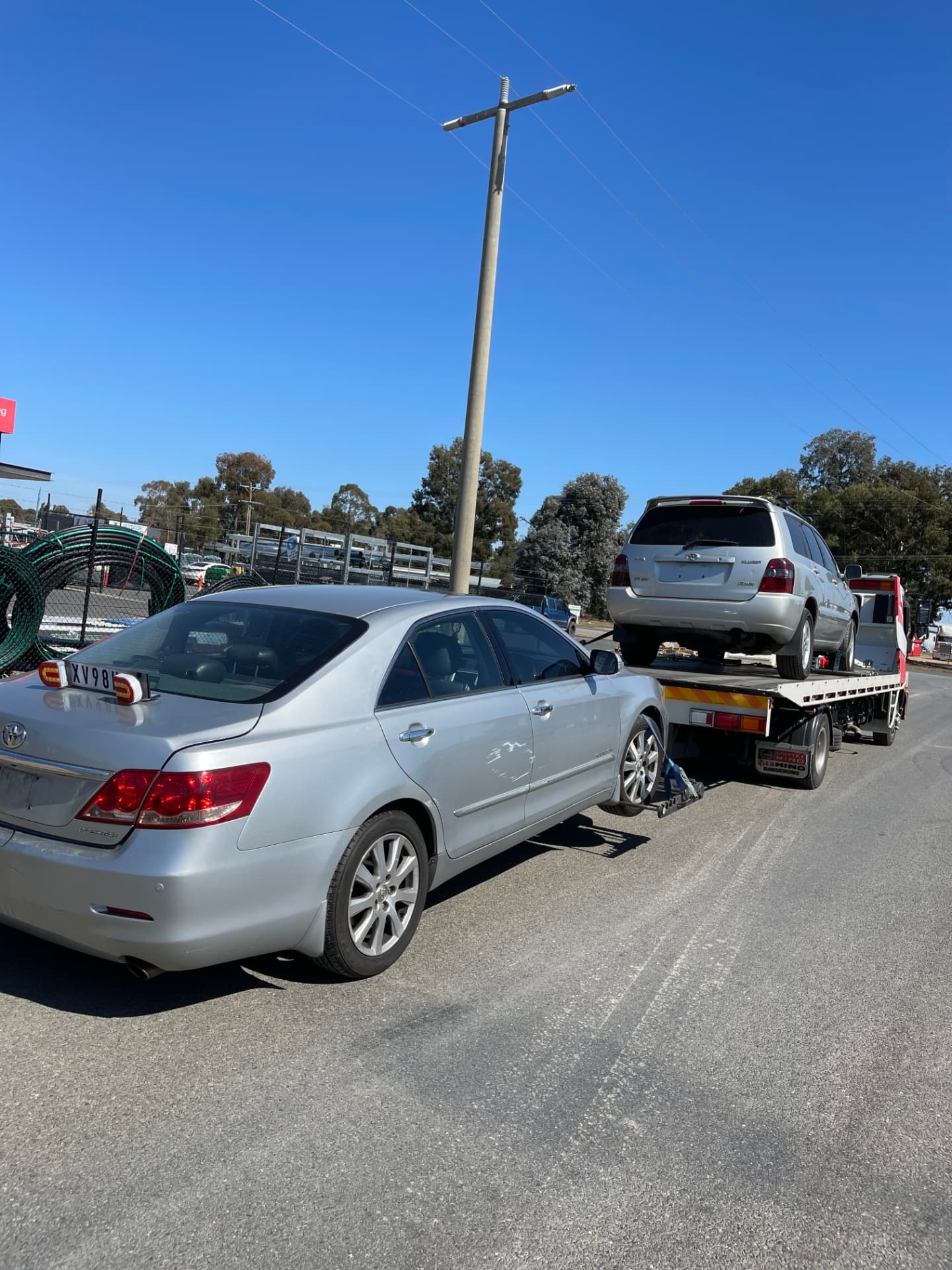 Tow truck carrying unwanted cars for removal